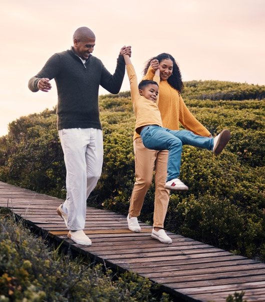 A family walking a boardwalk trail together