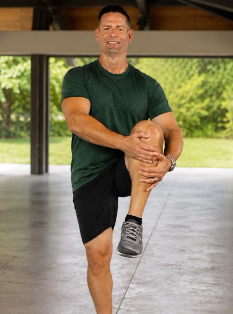 Coach Chris Wilson performing a kneeling hip stretch